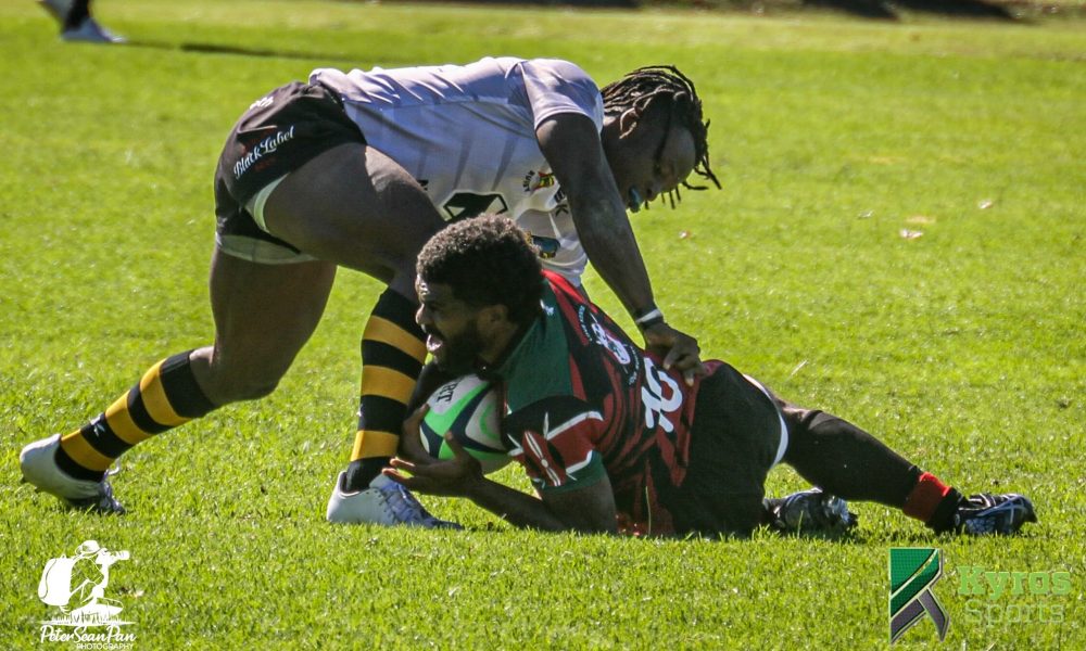 Kenya Simbas Jone Kubu brought down by a Zimbabwean Opponent. Photo Courtesy/ Kyros Sports