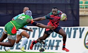 Kenya Simbas Brian Tanga paces past a senegalese opponent. Photo/Denis Acre-half