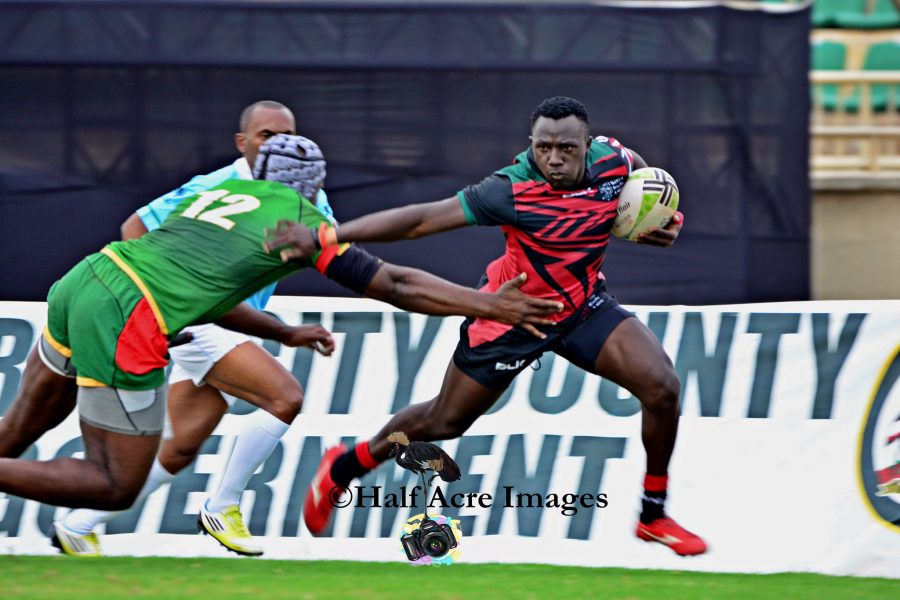 Kenya Simbas Brian Tanga paces past a senegalese opponent. Photo/Denis Acre-half