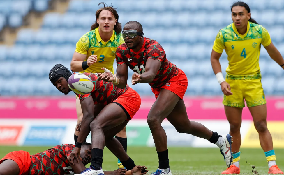 Kenya 7s Willy Ambaka launches an attack against the Australia defense on day two of the Birmingham 2022 Commonwealth Games at Coventry Stadium on 30 July, 2022 in Coventry, England. Photo credit: Mike Lee - KLC fotos for World Rugby