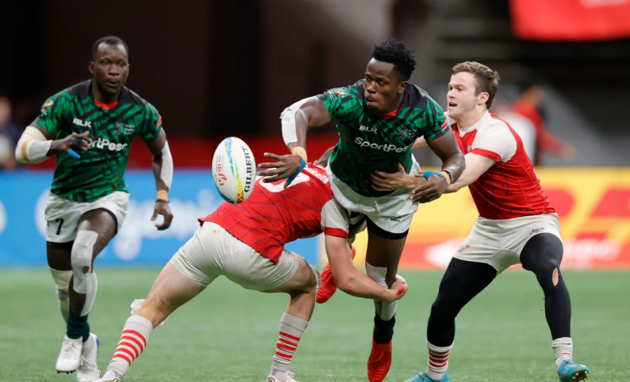 Kenya 7s John Okoth offloads against the Great Britain defense on day one of the HSBC Canada Sevens at BC Place Stadium on 3 March, 2023 in Vancouver, Canada. Photo credit: Mike Lee - KLC fotos for World Rugby