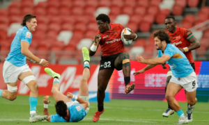 Kenya's Alvin Otieno charges through the Uruguay defense on day one of the HSBC Singapore Sevens at Singapore National Stadium on 8 April, 2023 in Kallang, Singapore. Photo credit: Mike Lee - KLC fotos for World Rugby