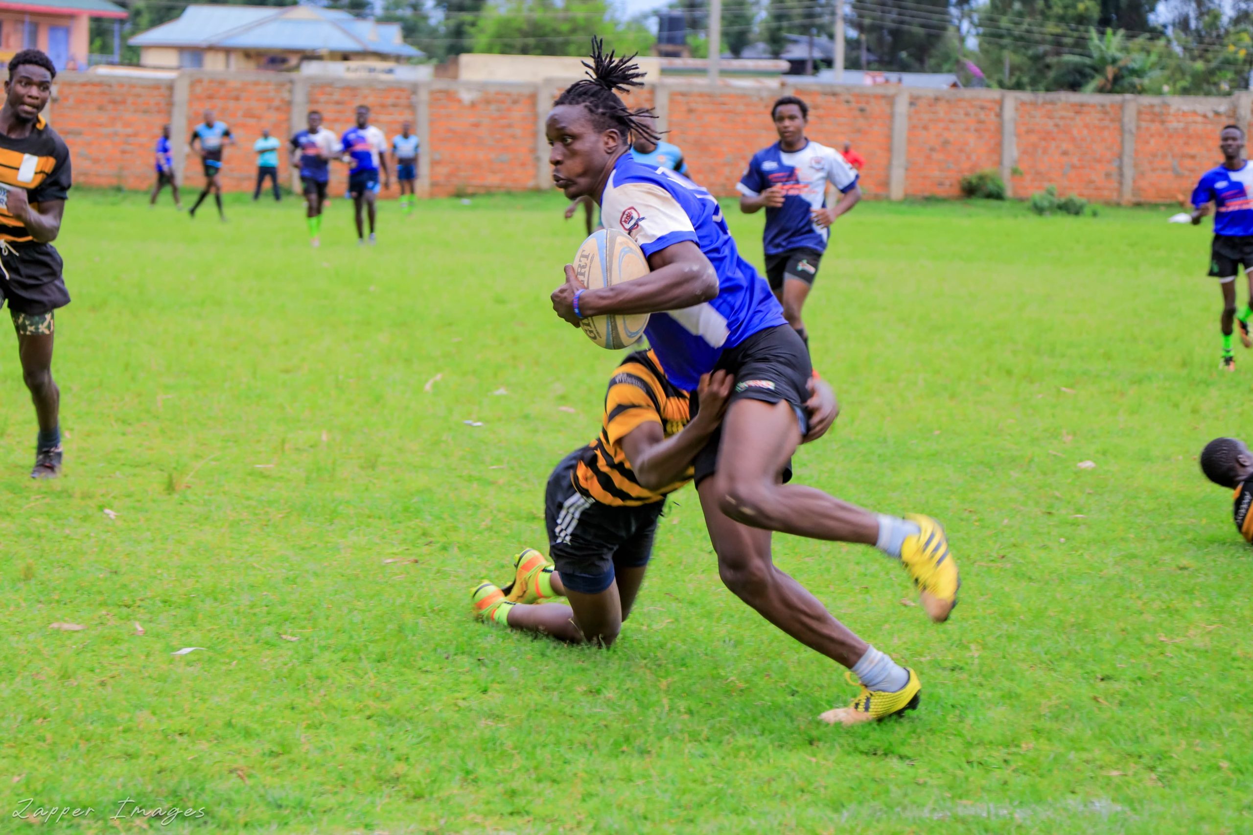 Kisii RFC Victory Gichana dodges tackle against Kisii Polytechnic/ photo: Zapper Images