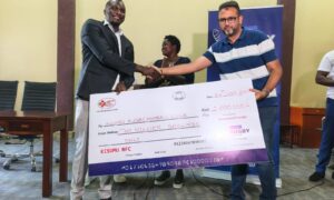 Kisumu RFC chairman Dr Gabriel Ouma receives a dummy cheque from Homeland Itoya events. PHOTO/Brian Mwenje