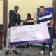 Kisumu RFC chairman Dr Gabriel Ouma receives a dummy cheque from Homeland Itoya events. PHOTO/Brian Mwenje