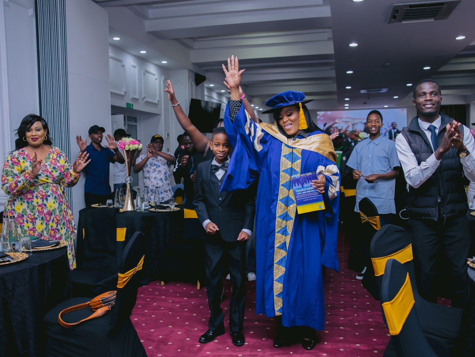 Dr. Margaret Awino Ong’ale, the first DCI female officer to earn a doctorate degree enjoys music during the launch.